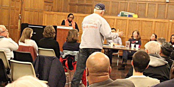 Guns Save Life’s Michael Mitev, a former political prisoner in Bulgaria in his youth, gives the would-be gun grabbers hell at the anti-gun organizational meeting held at the University of Illinois YMCA - in a room where all sorts of flags were displayed overhead, except for the American flag.