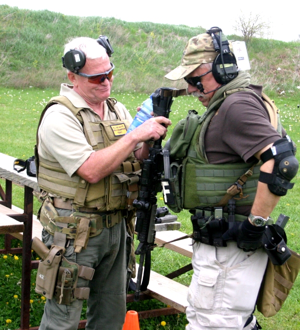 Pat Rogers helps Sheriff Ken Campbell with his gear. You can see his mind working, just pondering the next smart alec remark to share with us.